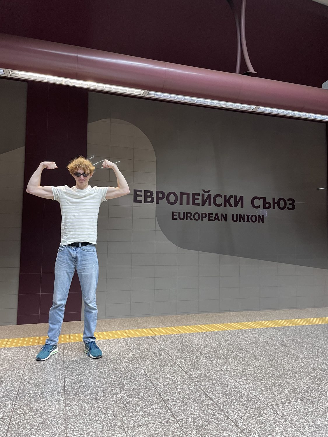 Felix Tinnerholm flexing in front of the European Union metro station sign in Sofia, Bulgaria